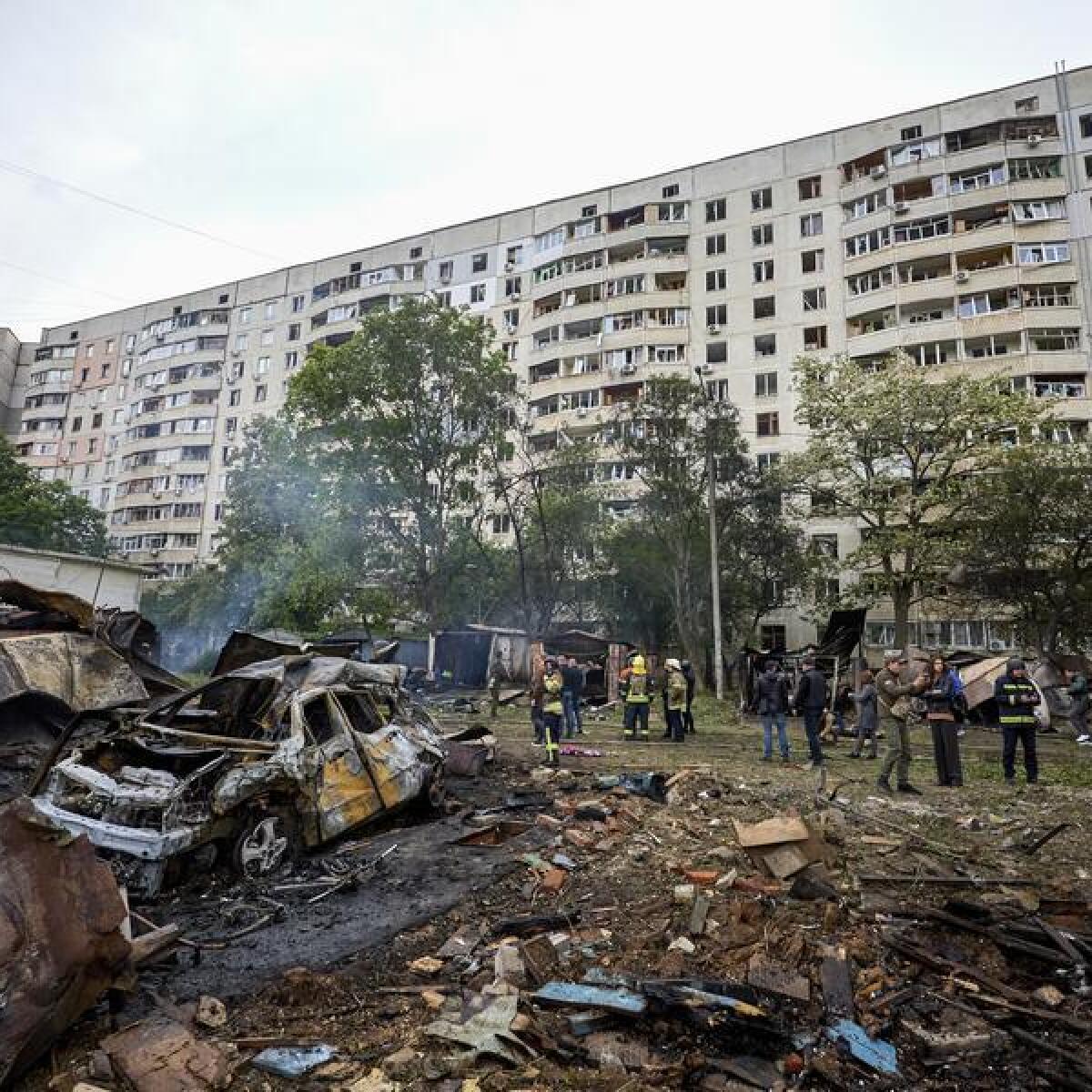 Rescuers work at the site of a shelling in Kharkiv