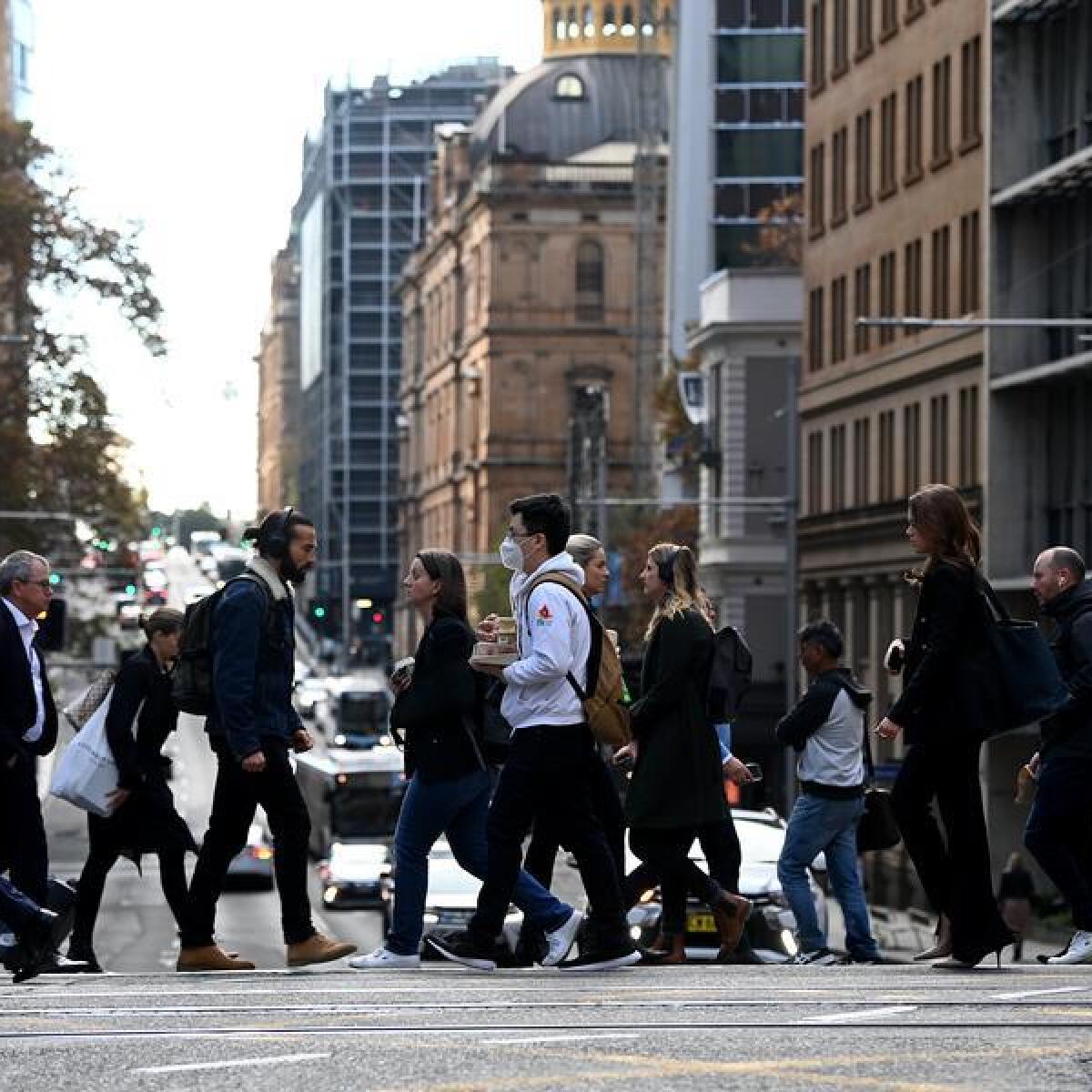 People are seen in the central business district of Sydney
