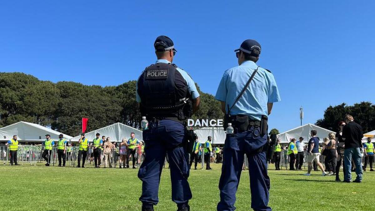 Officers watch revellers at the Listen Out music festival in Sydney