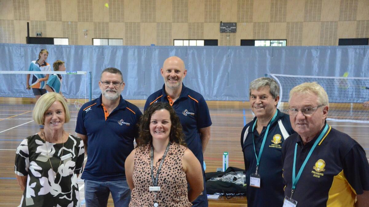 Representatives from Badminton Victoria, Shepparton Badminton Association and Greater Shepparton Secondary College stand smiling on the new badminton court. 