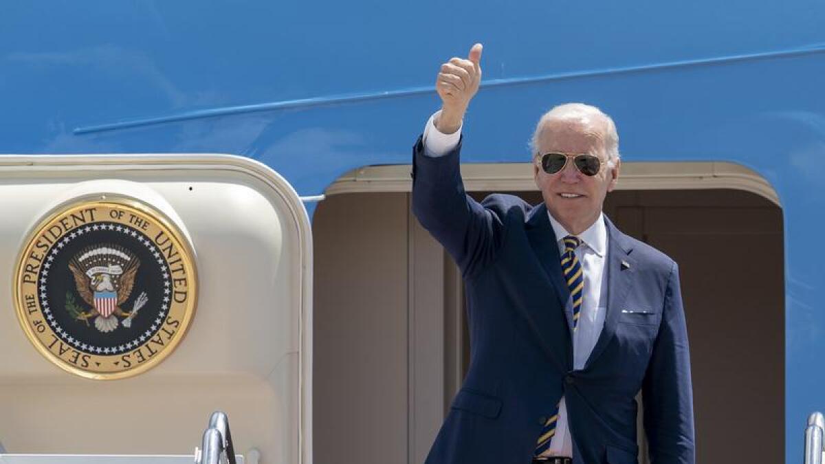 President Joe Biden gestures as he boards Air Force One