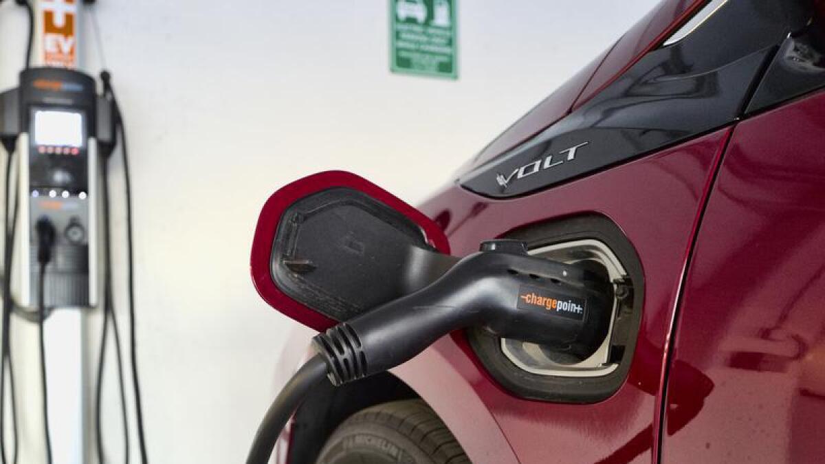 A Chevrolet Volt hybrid car charging at a ChargePoint charging station
