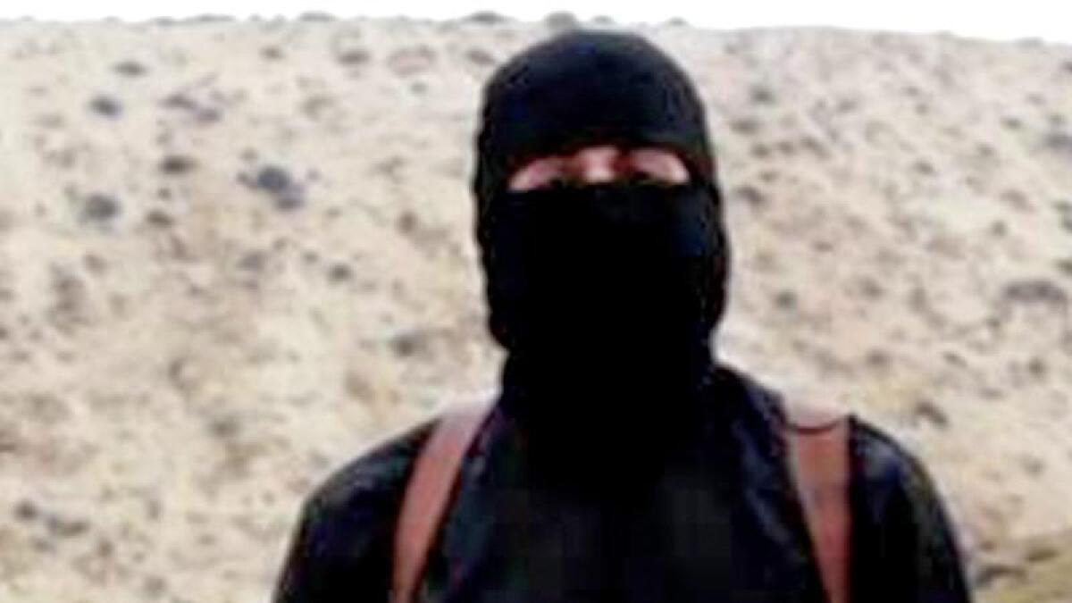 A file photo of an English-speaking IS member with a hostage