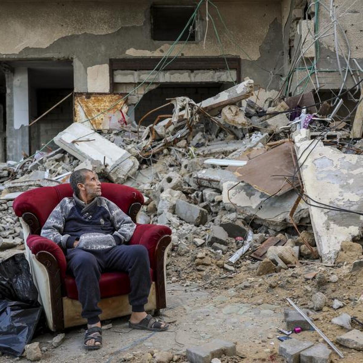 A Palestinian man sits in an armchair