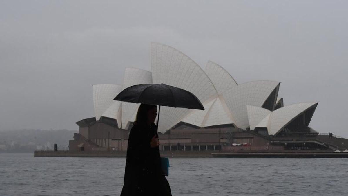 A person walks in the rain in Sydney