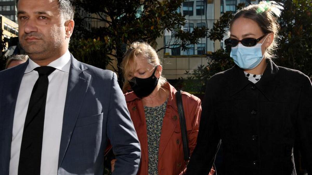 Dale Palmer (centre) arrives at the Downing Centre Local Court