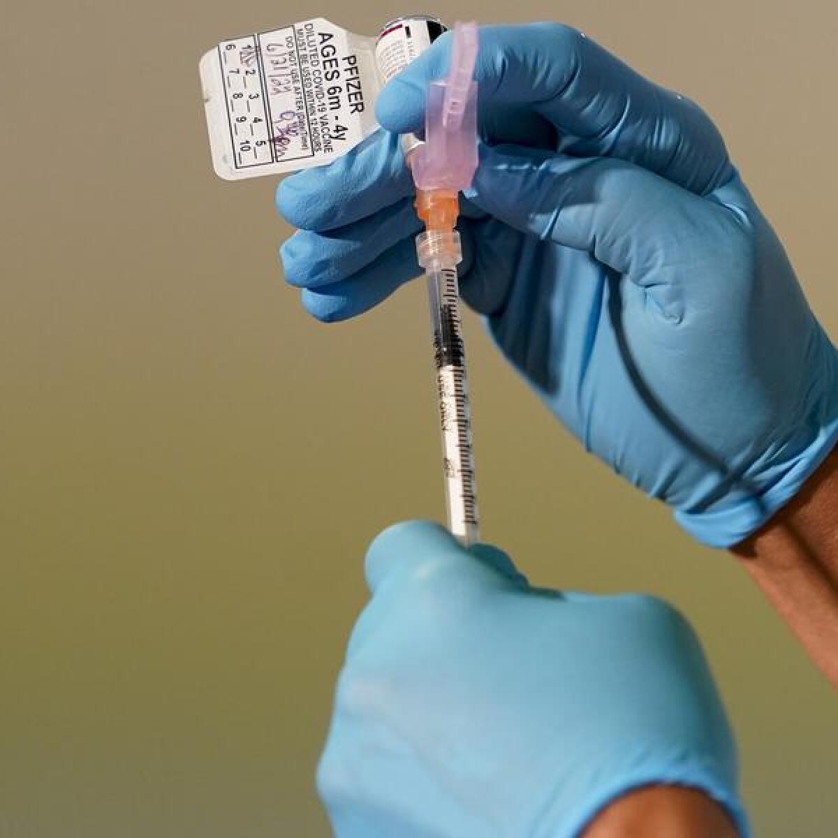 A nurse preparing a COVID-19 vaccine shot