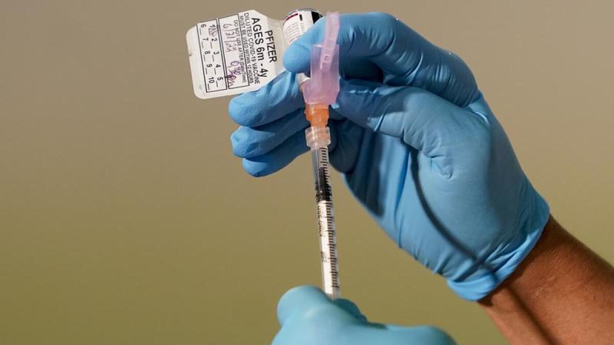 A nurse preparing a COVID-19 vaccine shot