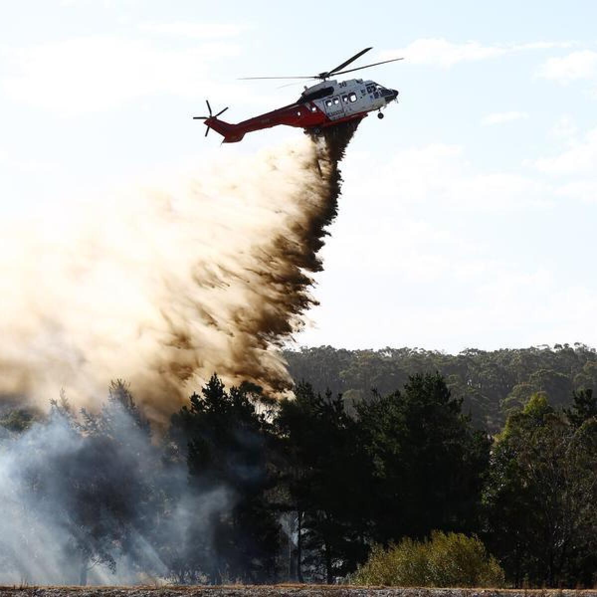 A helicopter fights a spot fire outside Beaufort, Victoria.