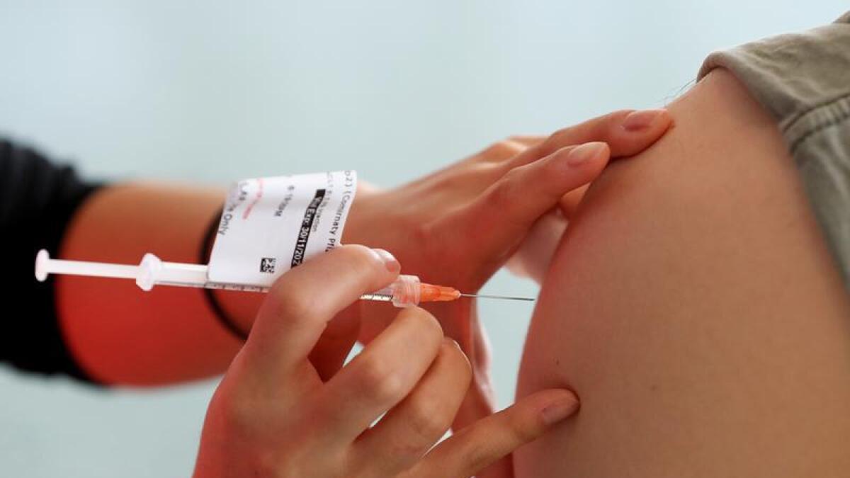 A COVID-19 vaccine is administered.