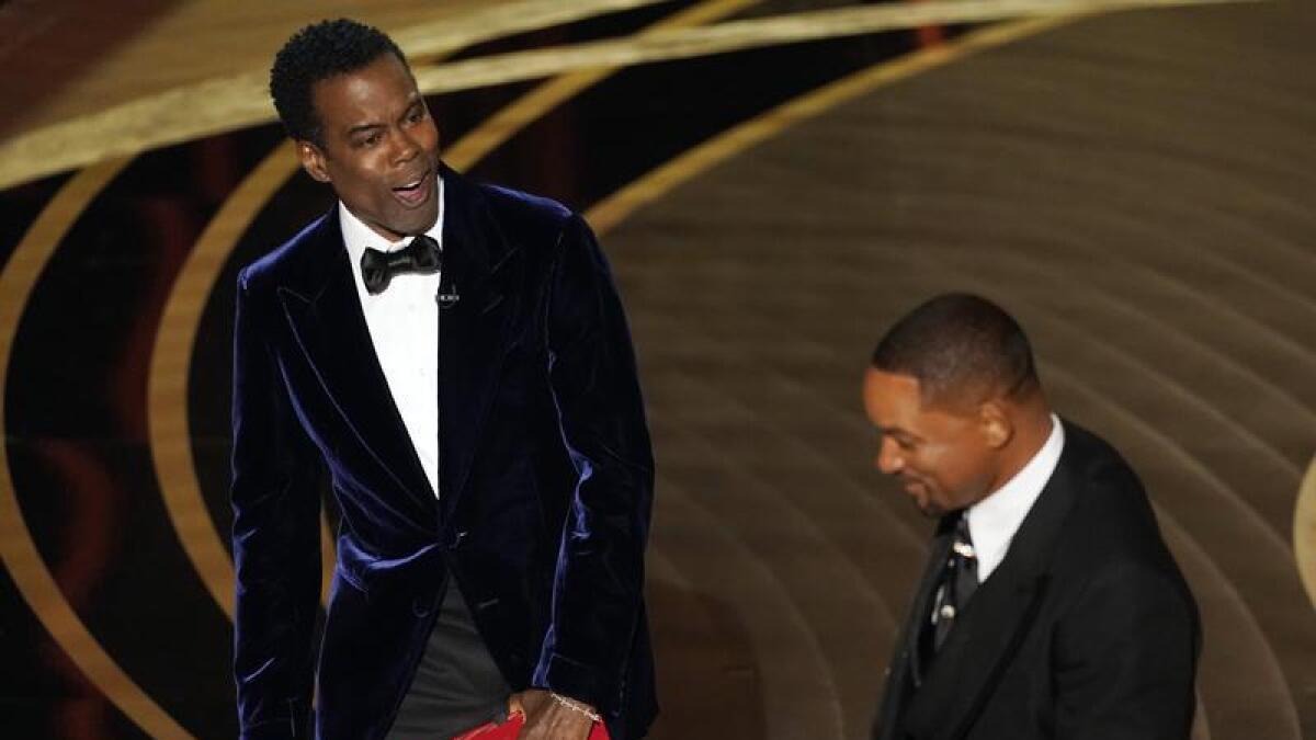 Chris Rock reacts after Will Smith slapped him onstage at the Oscars.