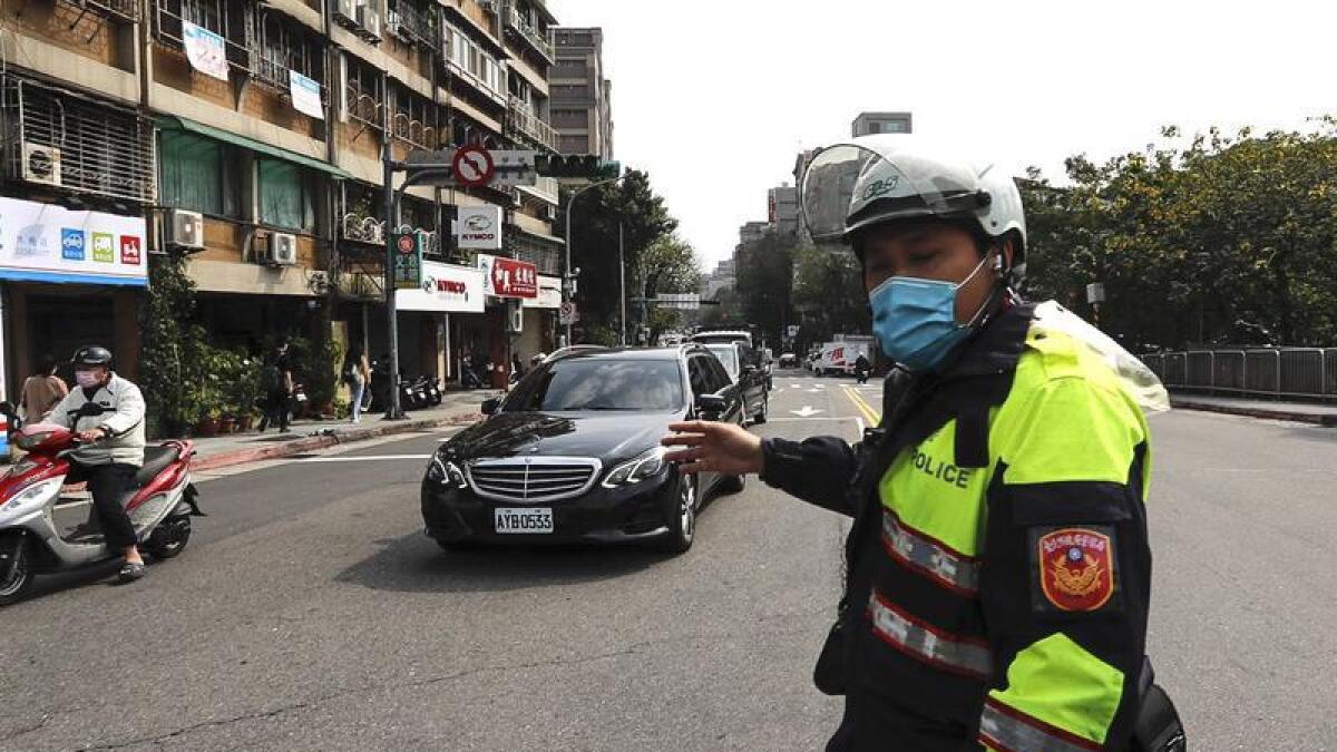 Police give instructions as traffic lights are down in Taipei