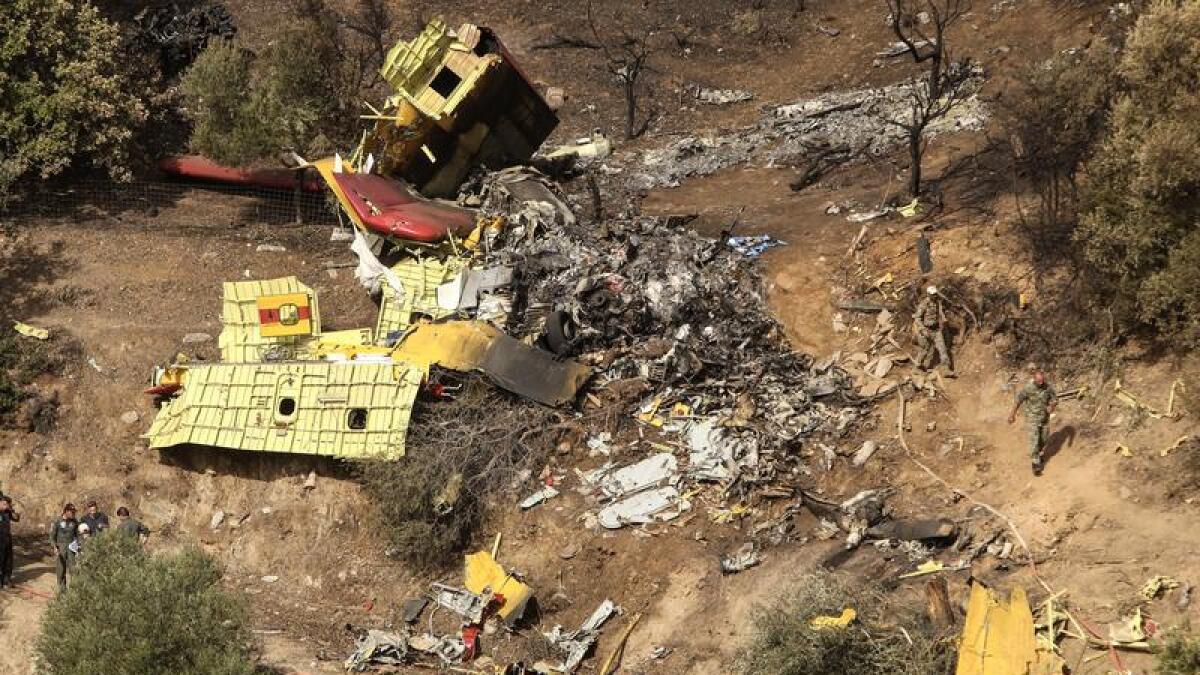The debris of a plane that crashed fighting fires in Greece 