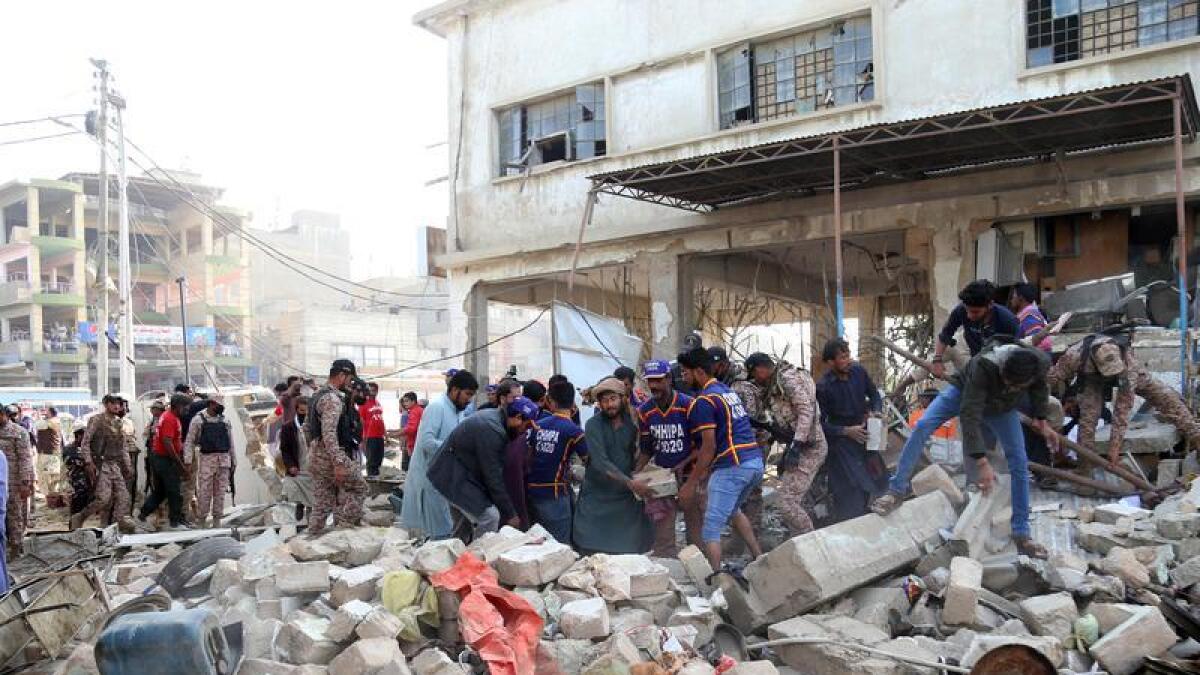 People search rubble after an explosion
