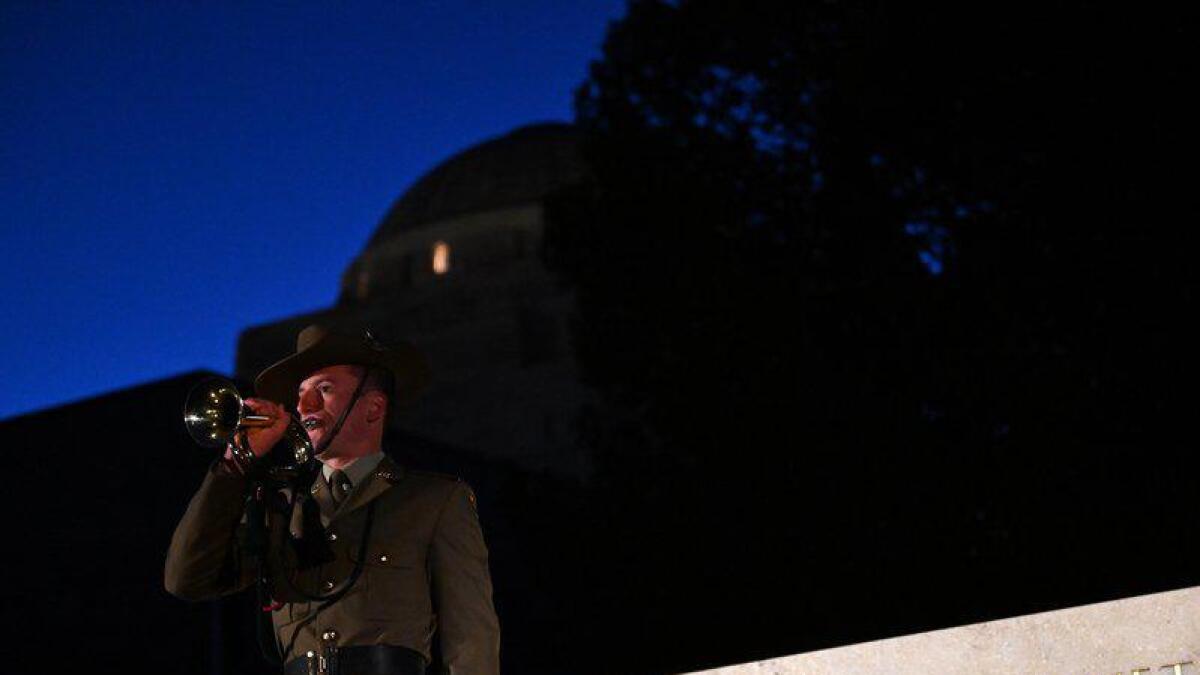 A member of the ADF plays the Last Post in Canberra.