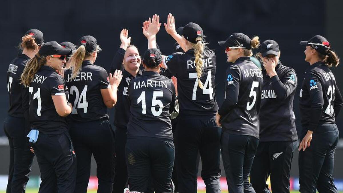 New Zealand players celebrate a wicket.