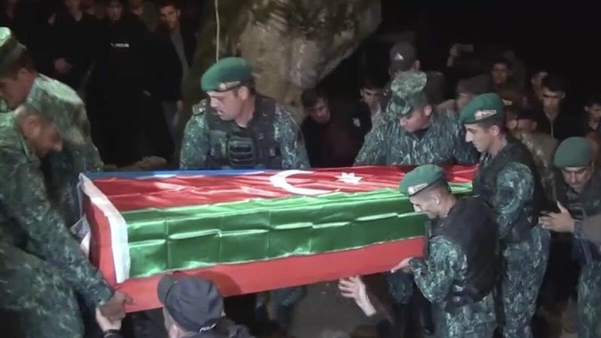 Servicemen carry the coffin of an Azerbaijani soldier.