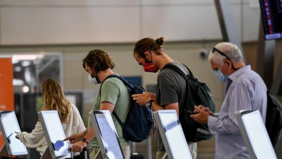 Passengers wear face masks at Sydney Airport.