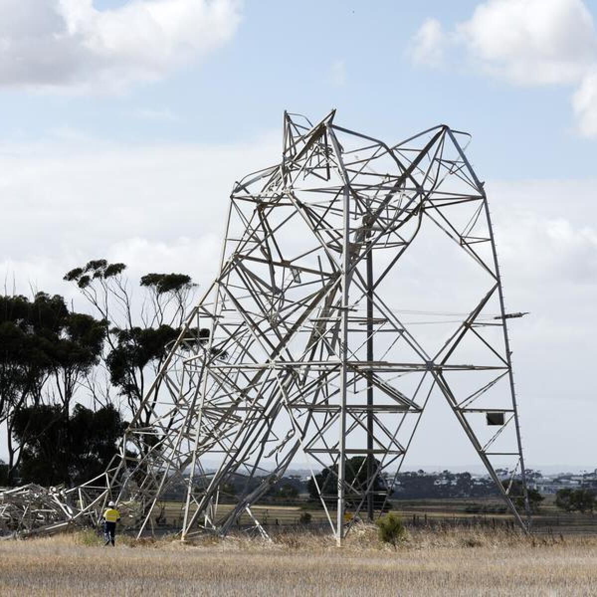 Workers inspect damaged electricity towers at Anakie in Melbourne