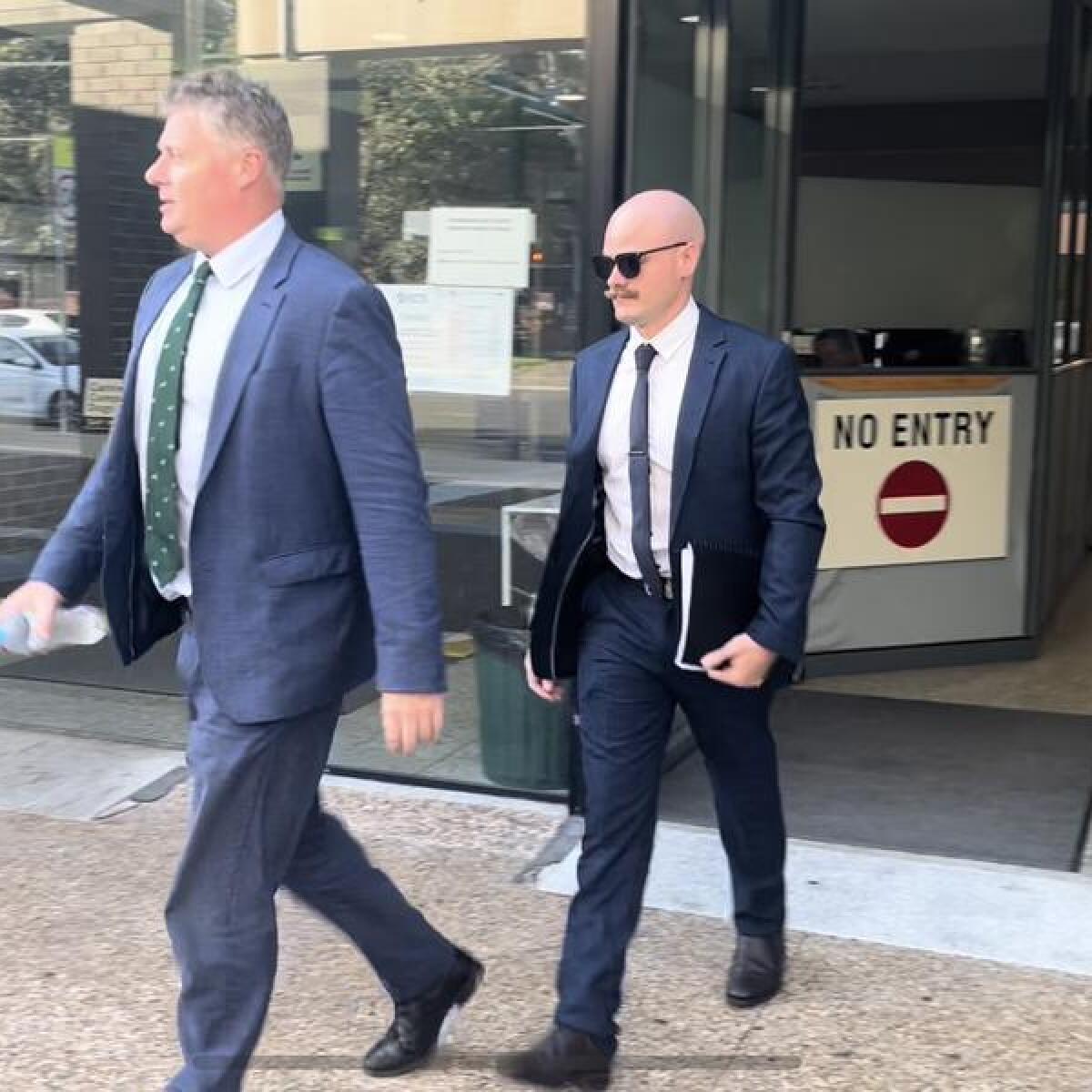 Alexander James Cox (right) leaves court with lawyer Paul McGirr.