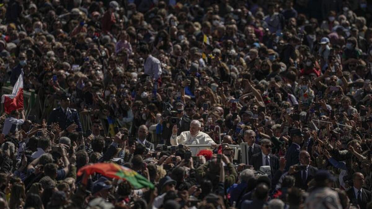 Pope Francis drives through the crowd at the end of the Easter mass.