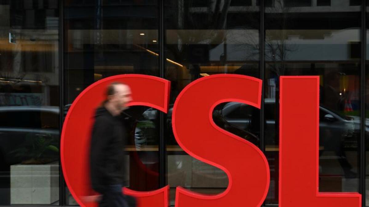 Person walking in front of a CSL sign.
