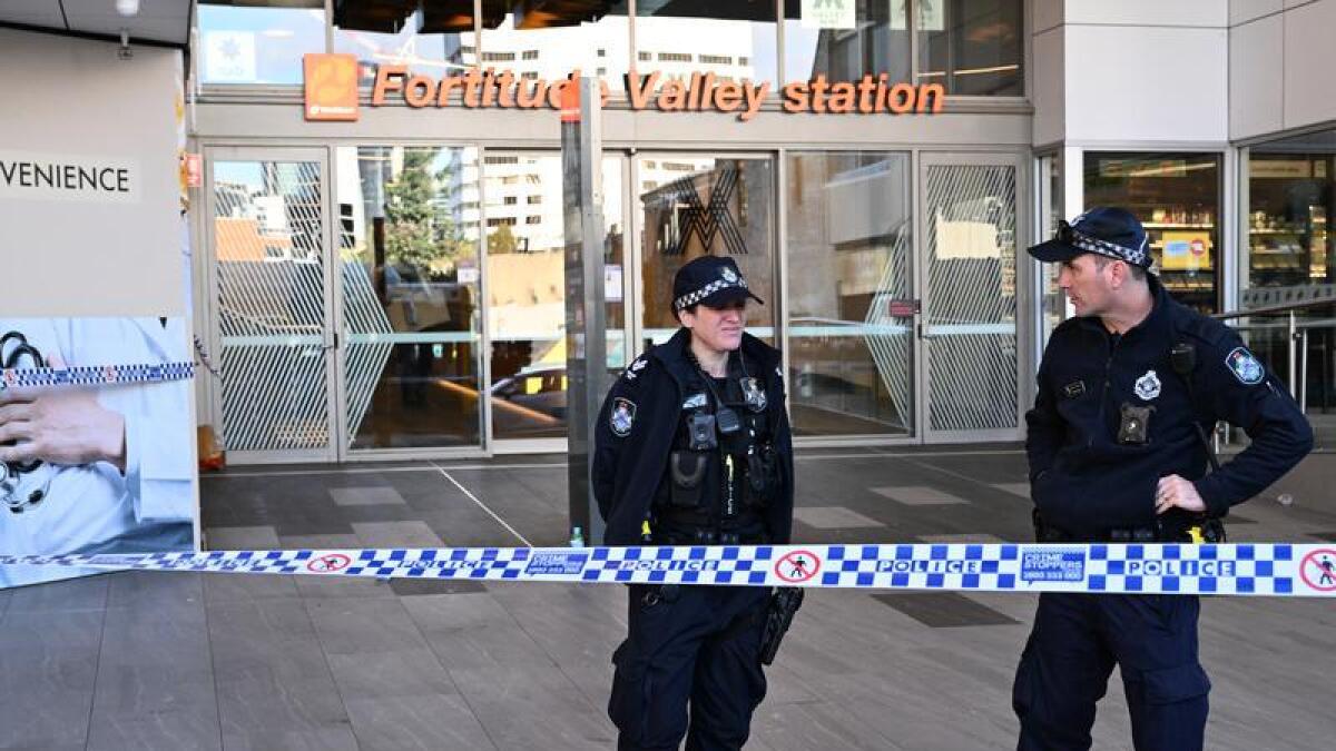 Police are seen outside the Fortitude Valley train station.