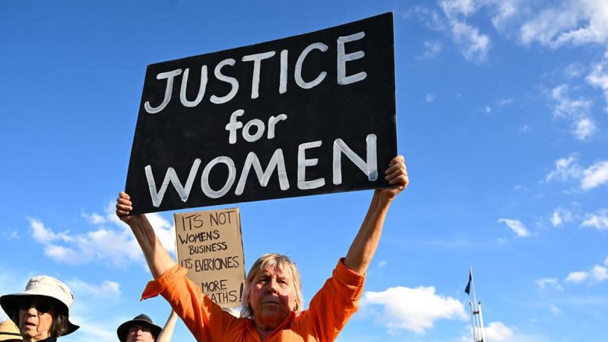 A woman at a rally to a call for action to end violence against women