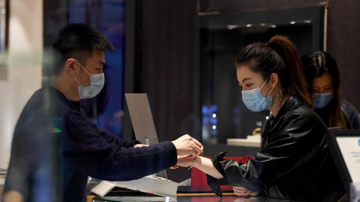 A shop worker and customer in Sydney.