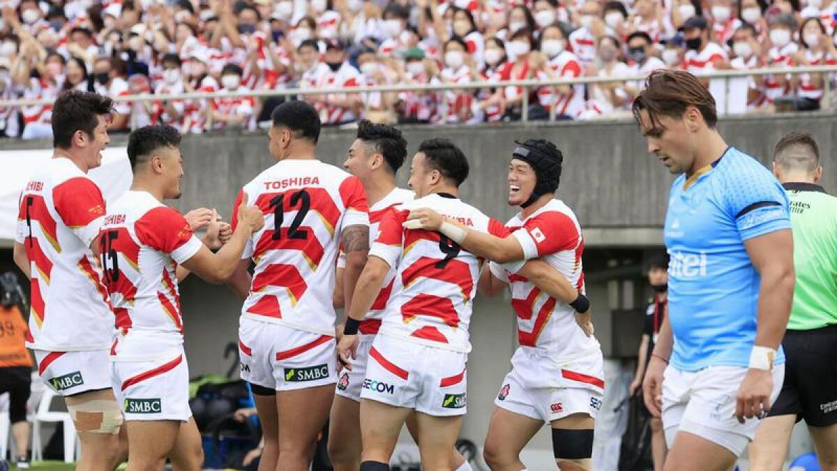 Japan celebrate after scoring a try.