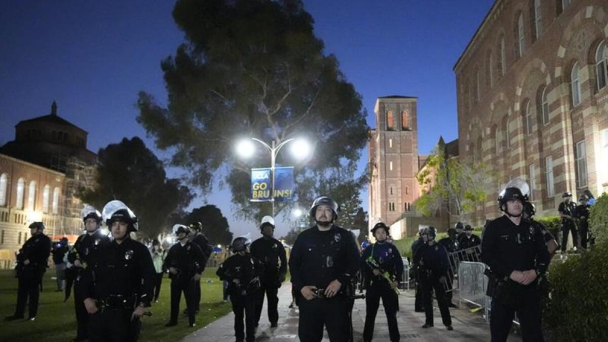 Police stage on the UCLA campus near a protest encampment