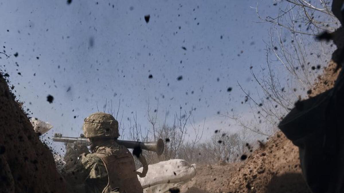 A Ukrainian soldier fires a grenade launcher near Bakhmut
