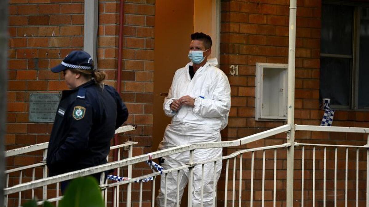 Police at a Sydney unit where a woman's body was found.