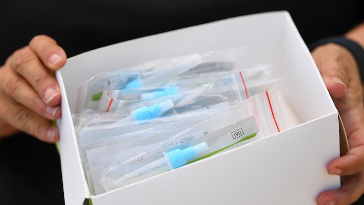 A box of Rapid Antigen Test kits