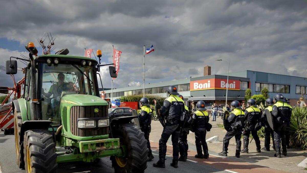 Dutch police fired shots when protesting farmers drove at them.
