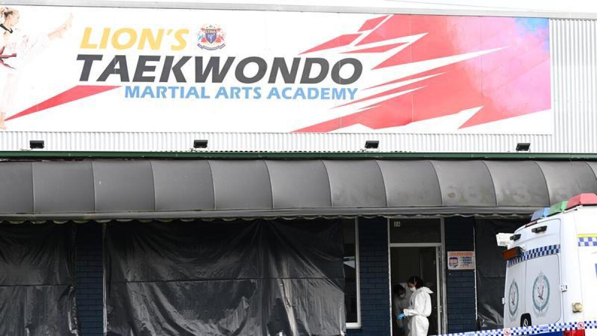 Police combed a taekwondo studio where two bodies were found.