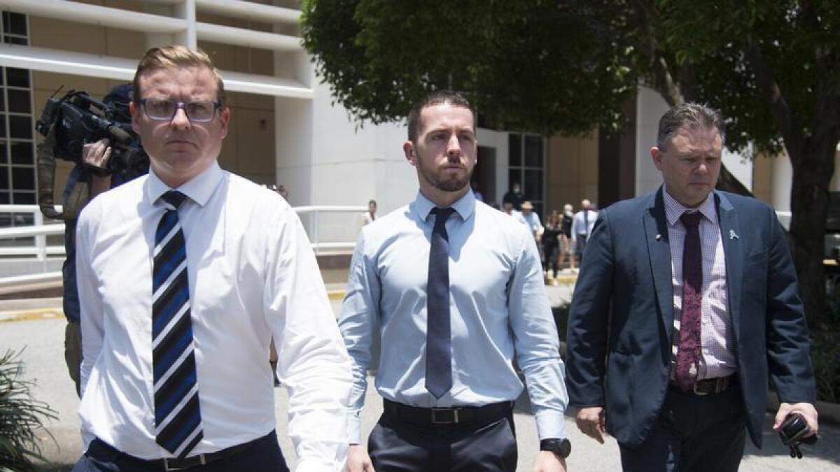 Zachary Rolfe (centre) departs the NT Supreme Court.