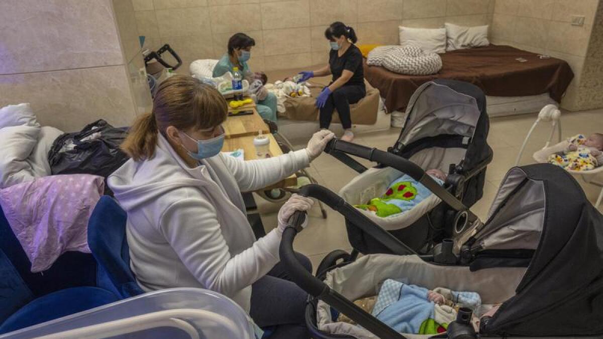 Nannies care for newborns at a converted basement in Kyiv, Ukraine.
