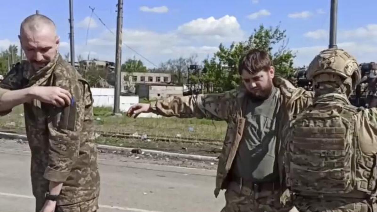 Russian troops search captured Ukrainian soldiers in Mariupol