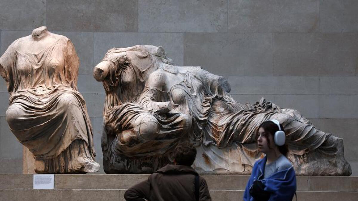 Visitors look at the Elgin marbles at the British Museum in London
