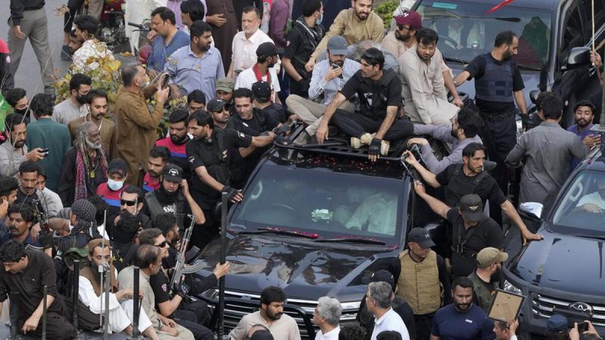 Imran Khan in car and supporters