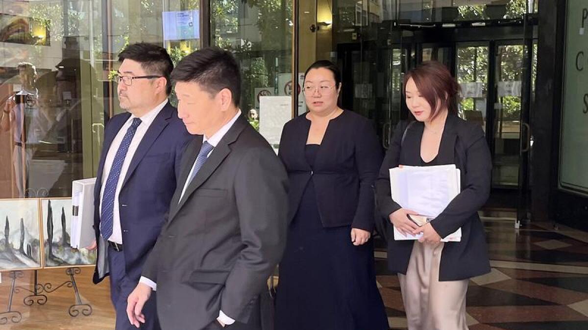 Jie Shao (second from right) leaves with her lawyer and supporters