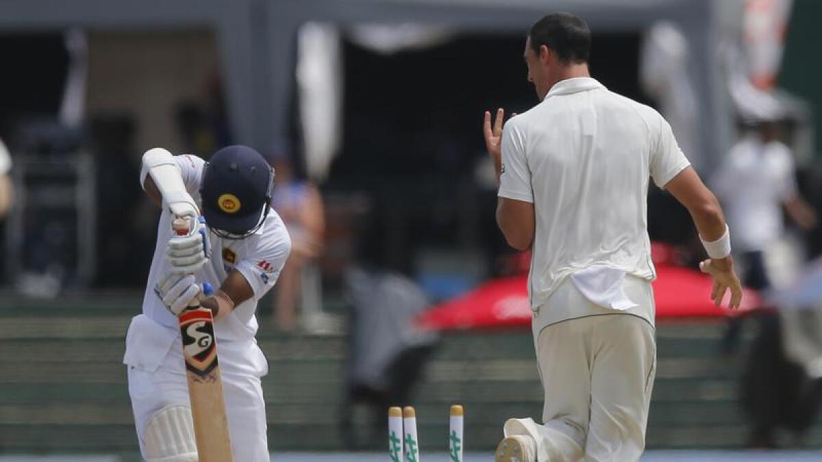 Mitchell Starc celebrates the wicket of Dimuth Karunaratne.