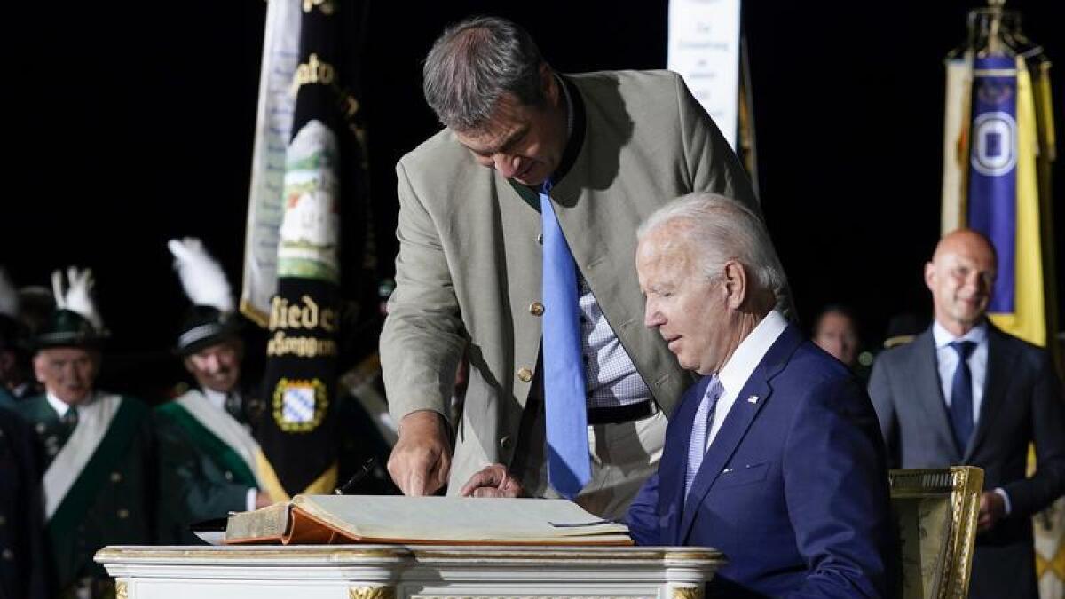 President Joe Biden signs a guest book at Munich International Airport