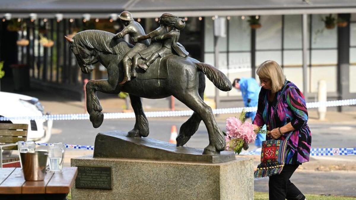A woman leaves flowers outside the Royal Hotel (file image)