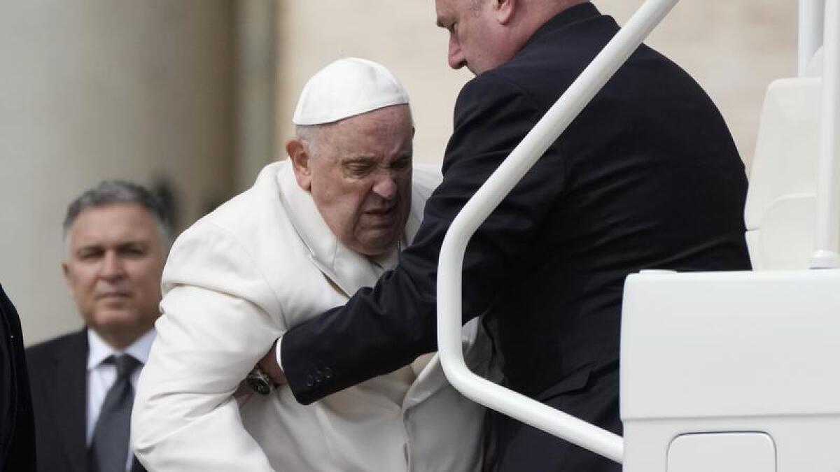 Pope Francis helped to get on his car in St Peter's Square