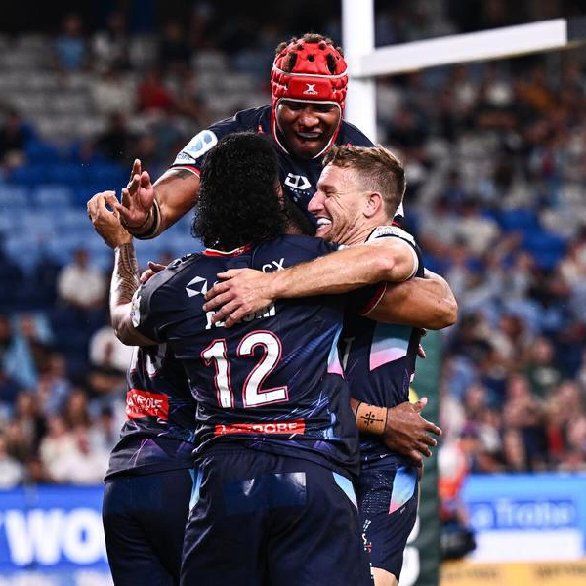 Melbourne players celebrating a try.