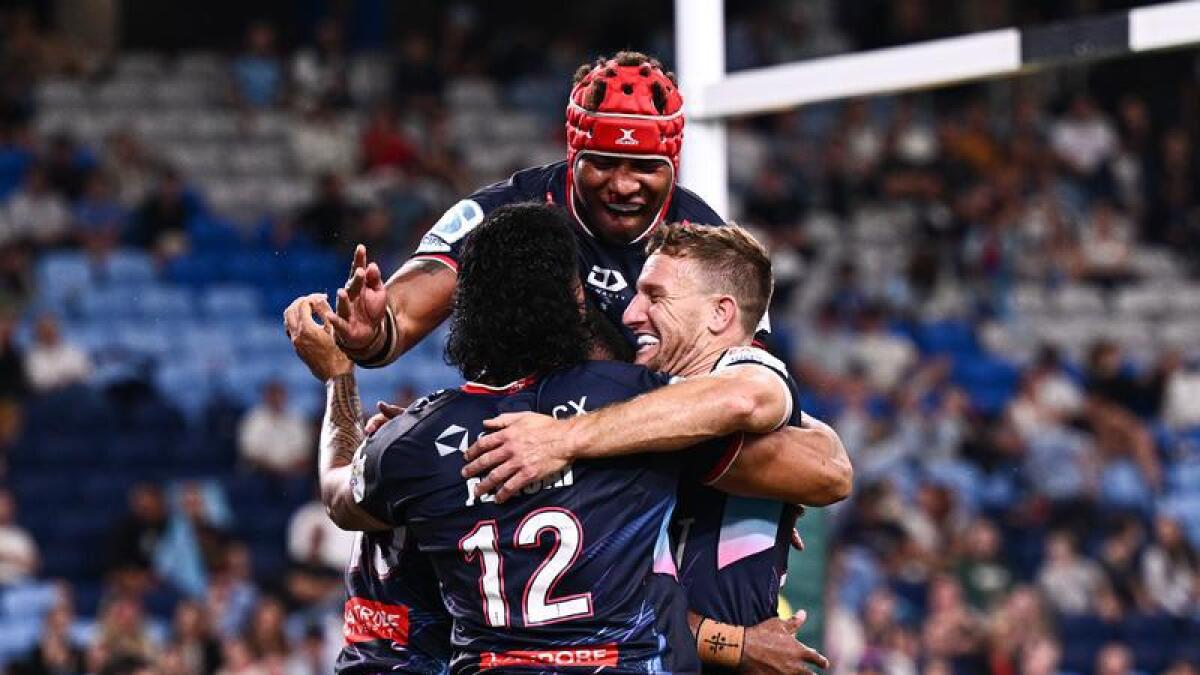 Melbourne players celebrating a try.
