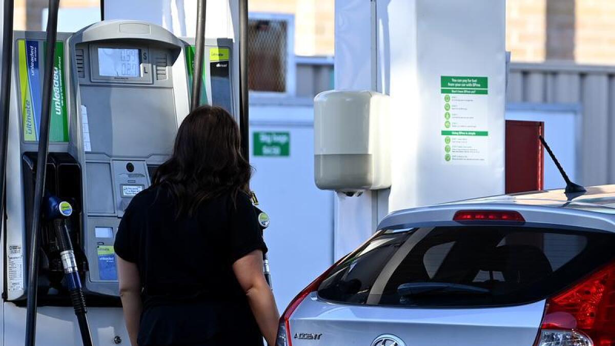 A file photo of a woman filling her car with petrol