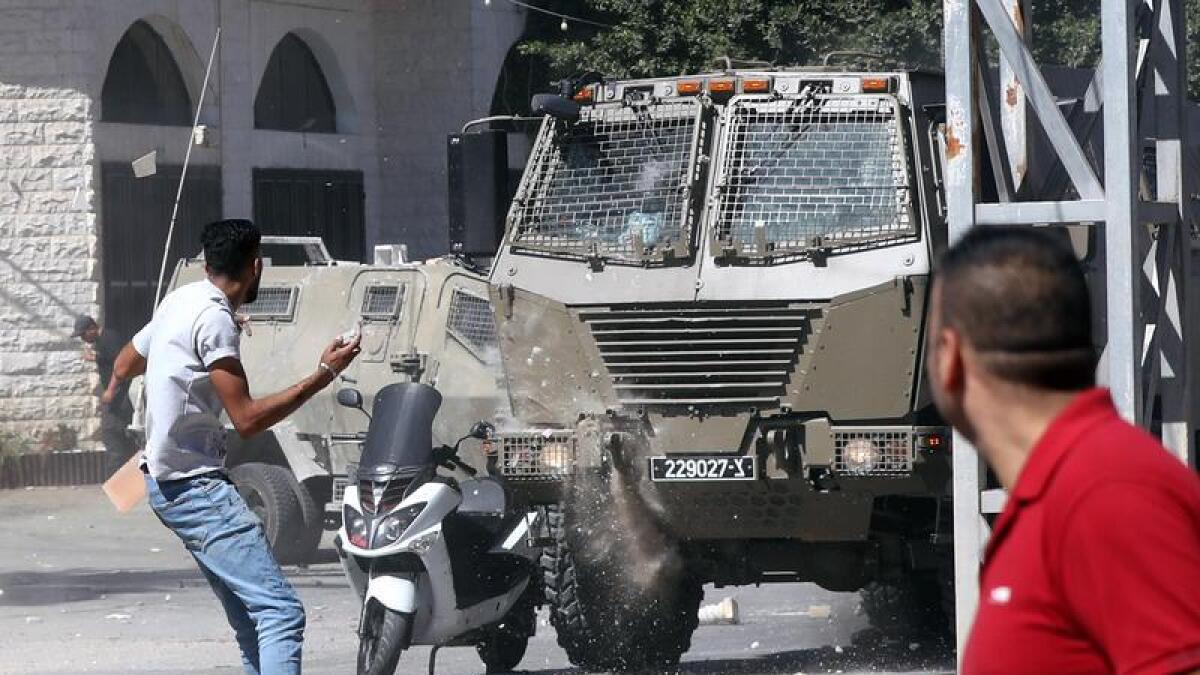 Palestinians clash with Israeli forces in the West Bank city of Jenin.